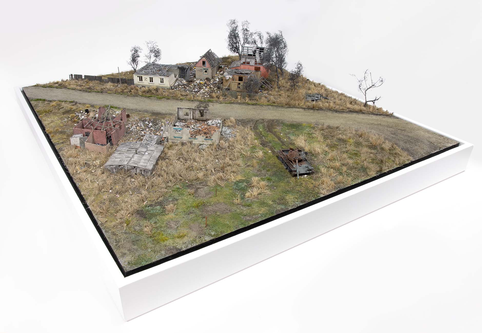 Model of a destroyed Russian tank near homes in the village of Kamianka, Ukraine, by artist Thomas Doyle for the Howard G. Buffett Foundation
