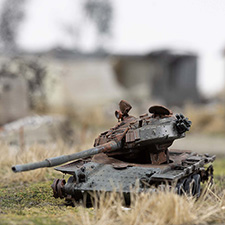 Thumbnail image of a model of a destroyed Russian tank near homes in the village of Kamianka, Ukraine, by artist Thomas Doyle for the Howard G. Buffett Foundation