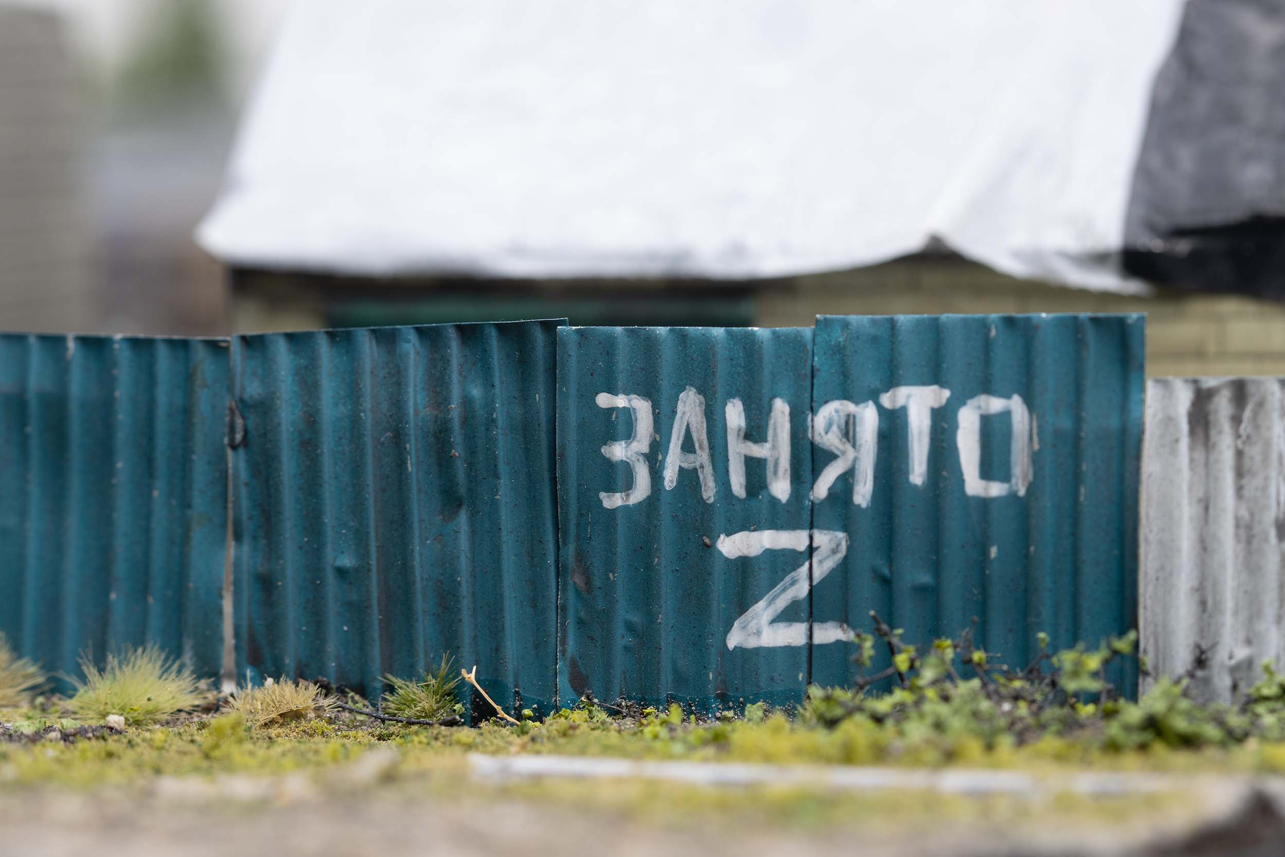 Model of damaged buildings with Russian graffiti in the village of Kamianka, Ukraine, by artist Thomas Doyle for the Howard G. Buffett Foundation
