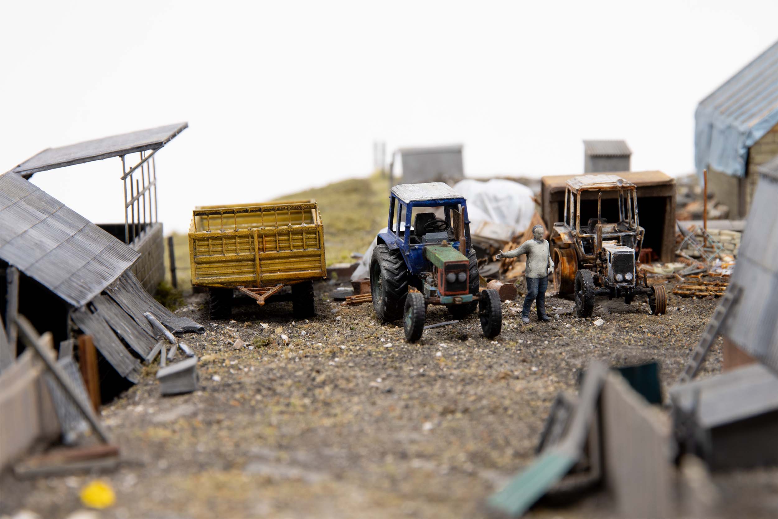Model of man standing near damaged tractor in the village of Kamianka, Ukraine, by artist Thomas Doyle for the Howard G. Buffett Foundation