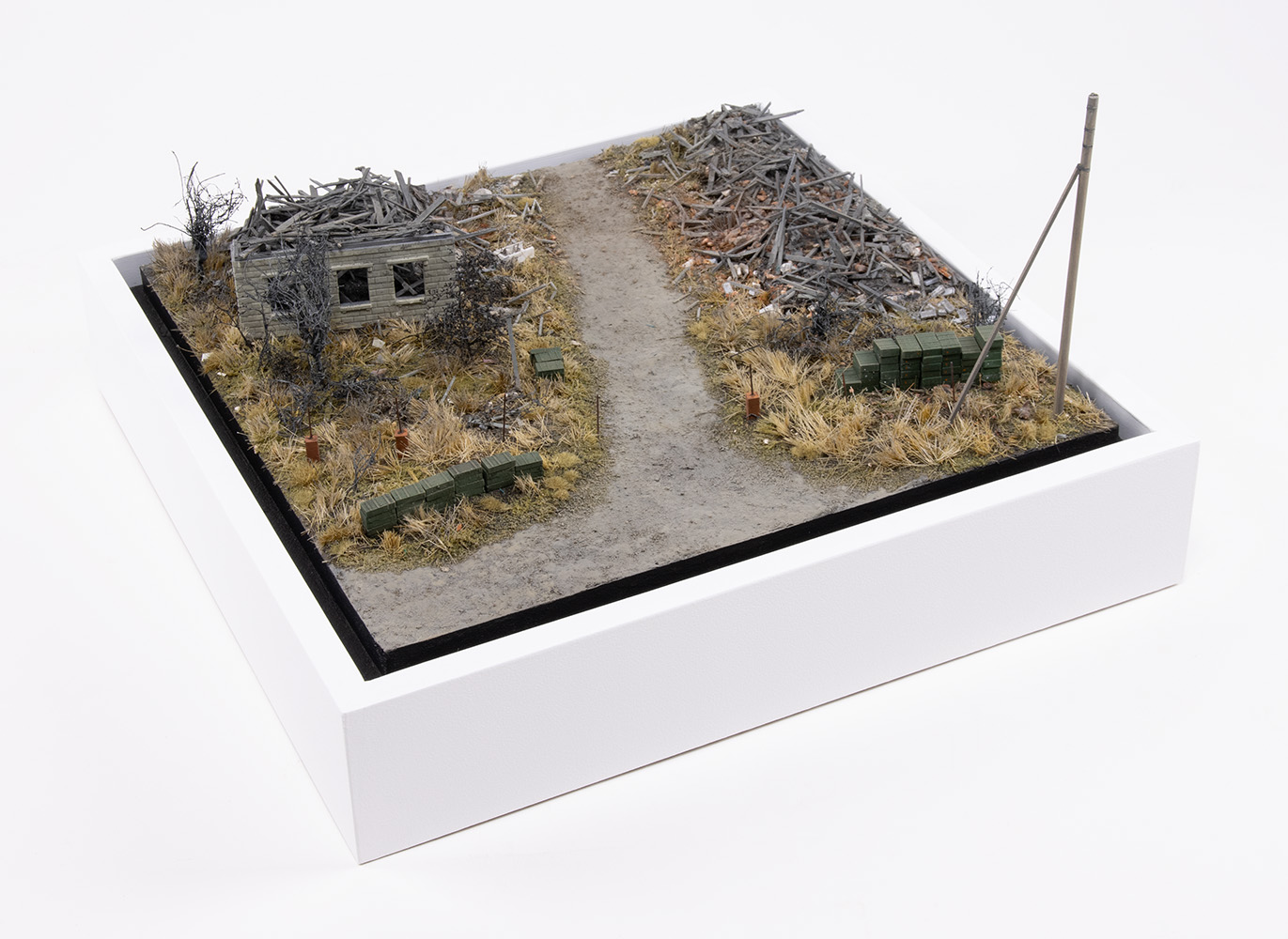 Model of ammunition crates stacked near destroyed homes in the village of Kamianka, Ukraine, by artist Thomas Doyle for the Howard G. Buffett Foundation