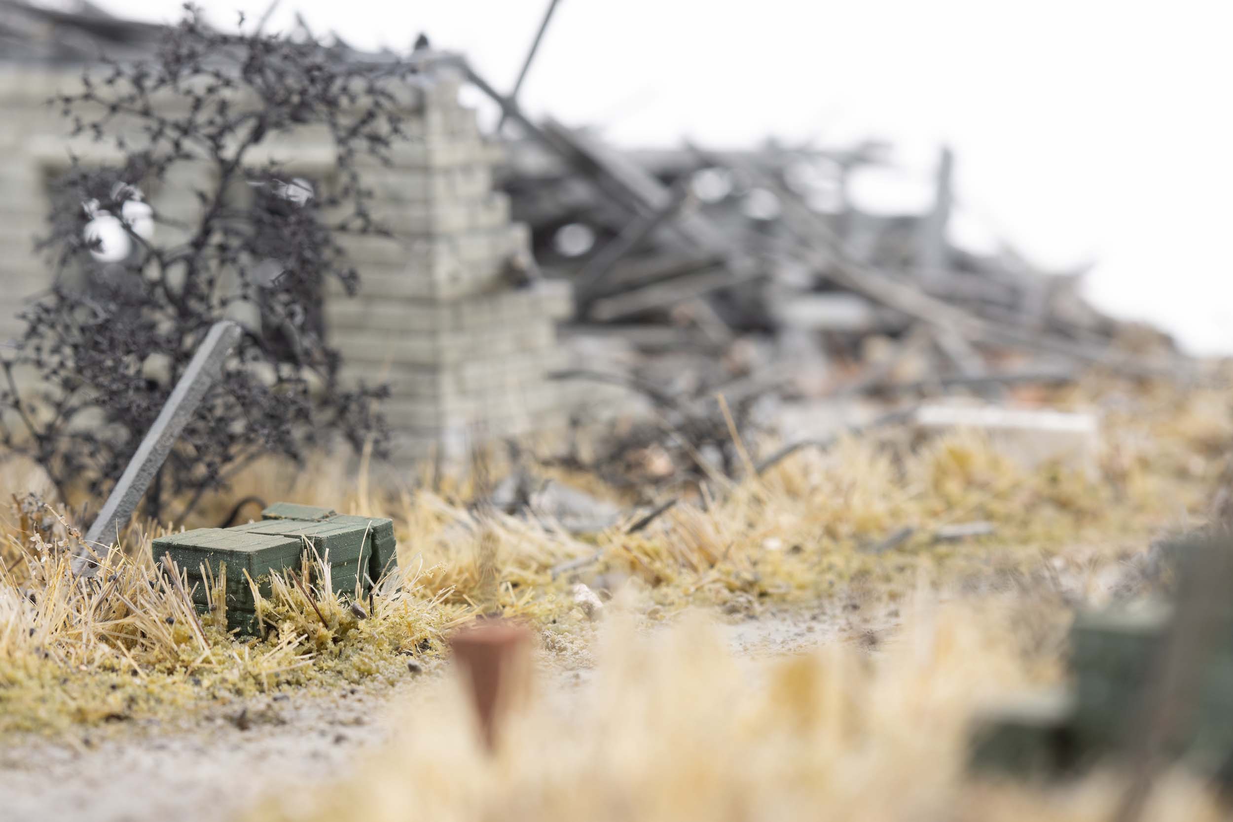 Model of ammunition crates stacked near destroyed homes in the village of Kamianka, Ukraine, by artist Thomas Doyle for the Howard G. Buffett Foundation