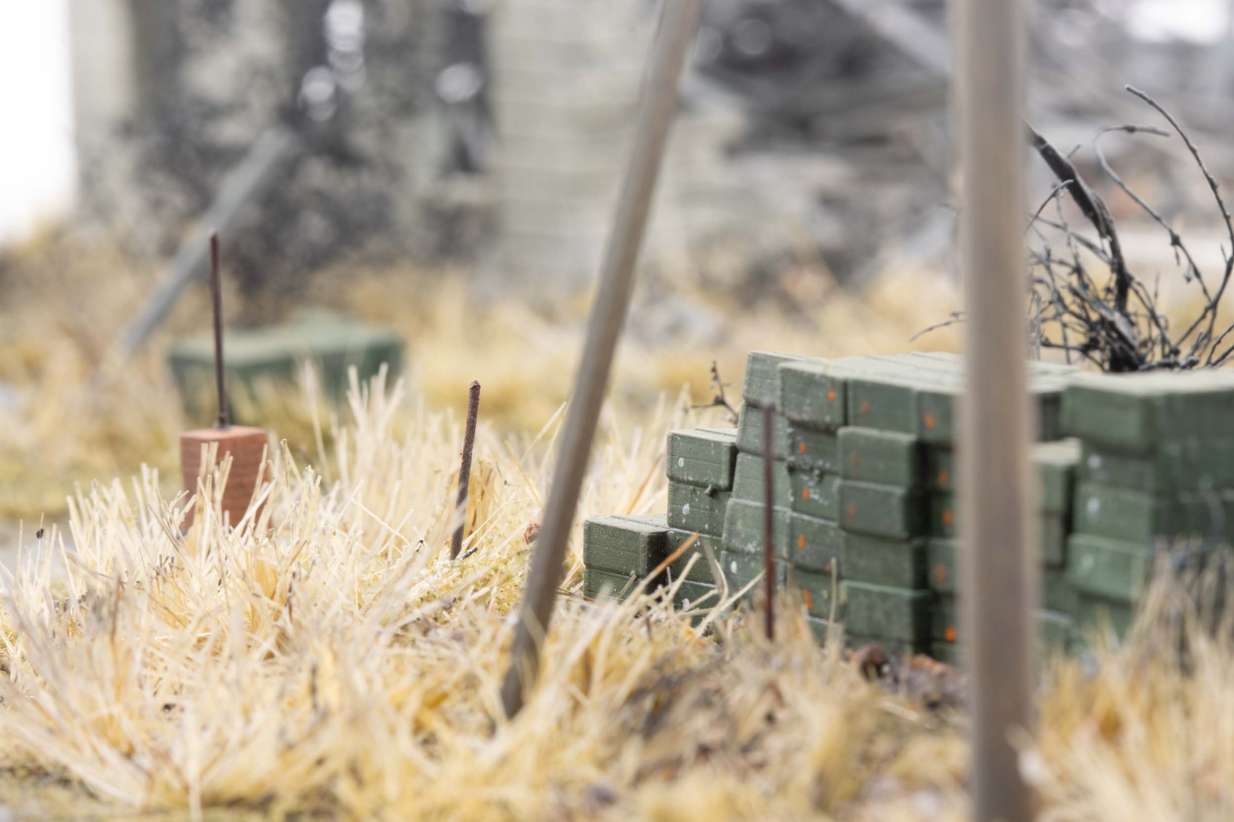 Model of ammunition crates stacked near destroyed homes in the village of Kamianka, Ukraine, by artist Thomas Doyle for the Howard G. Buffett Foundation